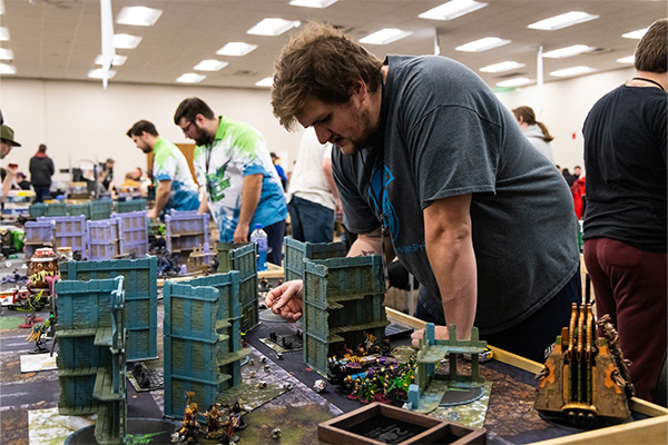 DSU student looks over tabletop game at Nanocon.